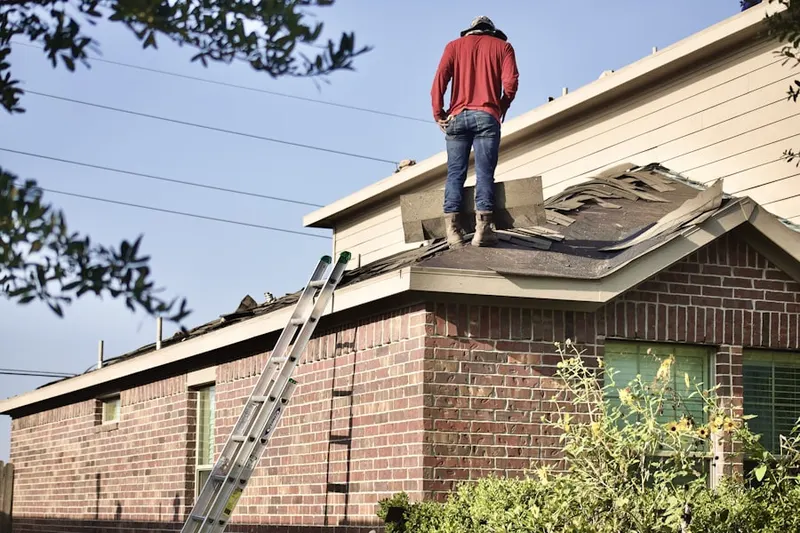 Professional roofer working on a residential roof in Cross Country